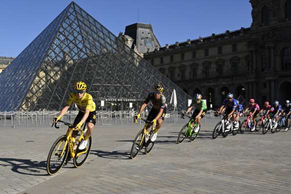 Yellow jersey Jonas Vingegaard passes the Louvre en route to the Champs-Elysees. 