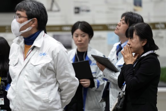 JAXA staff watching the live video of the pinpoint moon landing operation.