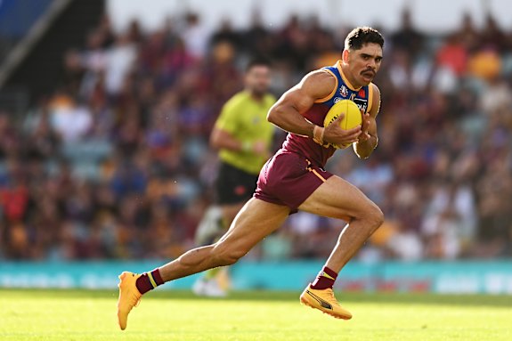Charlie Cameron of the Lions runs with the ball before kicking a goal during the round 7 clash.