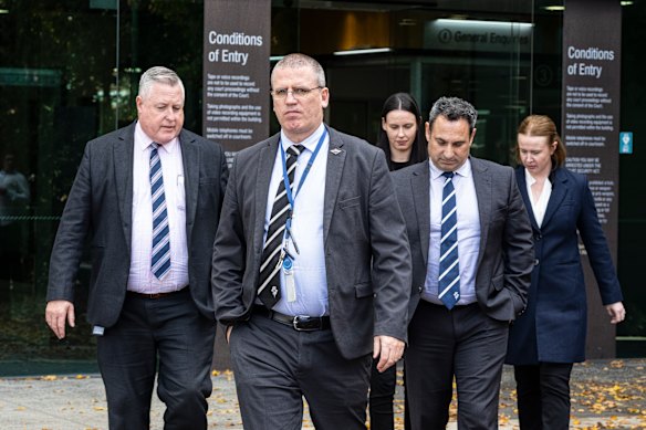 Police informant Detective Acting Sergeant Stephen Eppingstall leads out members of the Homicide Squad on Tuesday.
