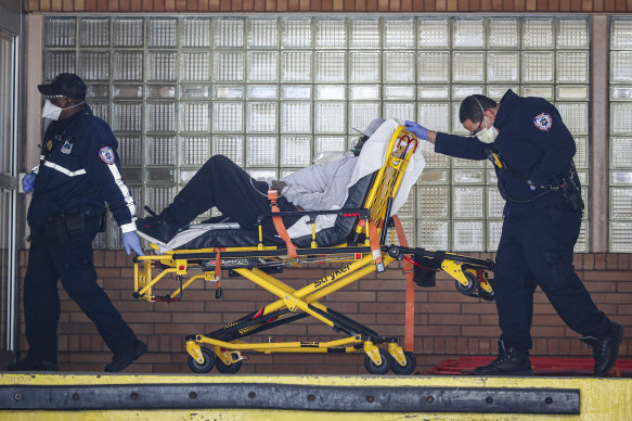 Paramedics wheel a patient into the emergency room at Wyckoff Heights Medical Centre in New York.