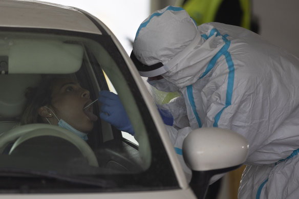 An woman is tested for coronavirus at a drive-through testing center in Tel Aviv on Monday.