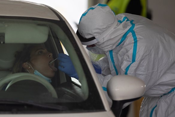 An woman is tested for coronavirus at a drive-through testing center in Tel Aviv on Monday.