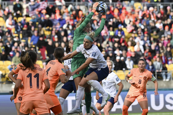 Netherlands’ goalkeeper Daphne Van Domselaar takes the ball and is clattered into by a USA’s Julie Ertz.