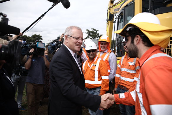 Scott Morrison meeting engineers working on a roads project in the 2019 federal election. He had recently announced a cut in migration numbers, citing pressure on the nation’s infrastructure.