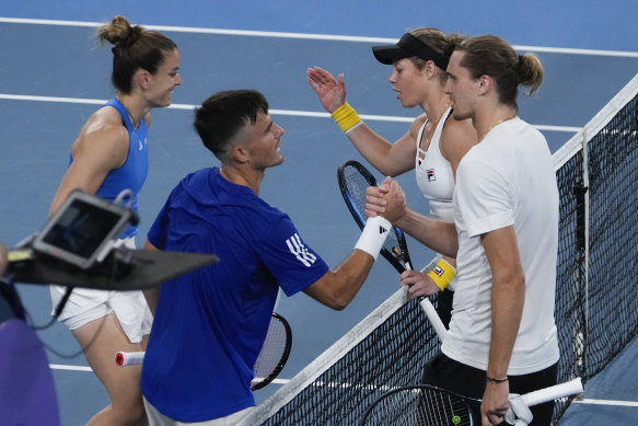 Germany’s Laura Siegemund and Alexander Zverev are congratulated by Maria Sakkari and Petros Tsitsipas.