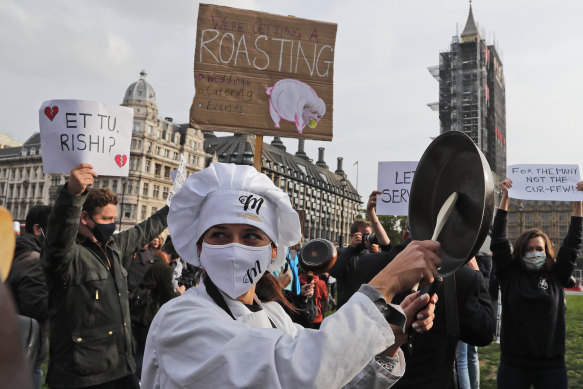 Hospitality workers protest at Parliament square, London, to urge the government to do more to help the industry.