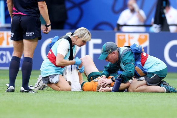 Tate McDermott receives medical attention during Australia’s Test with Georgia.