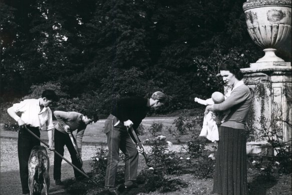 Lady Hertford brings her son, Henry Jocelyn Seymour (the current Lord Hertford), to the garden of Ragley Hall to watch her husband and his two teenage servants doing a spot of gardening.