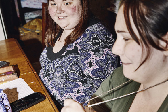 Megan Charest (left) and Nicole Parrish play a game led by Nicole’s husband.