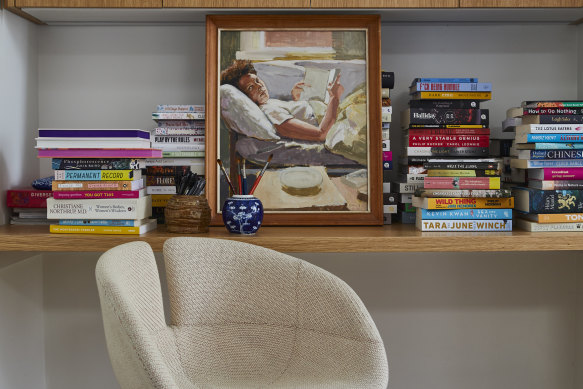 Books overflow onto the desk in the family room, alongside a portrait of Julie, group managing director at Hardie Grant Publishing, that Carlo painted in 1991.