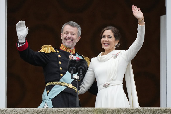 Denmark’s King Frederik X and Queen Mary wave from the balcony of Christiansborg Palace in Copenhagen, Denmark.