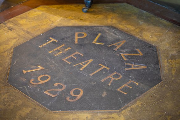 The original Plaza Theatre plaque in the foyer’s floor.