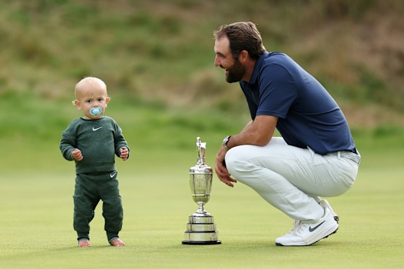 Scottie Scheffler of the United States celebrates with his son Bennett Scheffler and the Claret Jug on the 18th green after winning The 153rd Open Championship at Royal Portrush Golf Club on July 20, 2025 in Portrush, Northern Ireland.