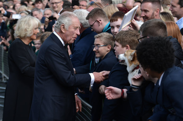 King Charles III and the Queen Co<em></em>nsort talk to students and pat “Co<em></em>nnie the corgi” in Hillsborough, Northern Ireland.