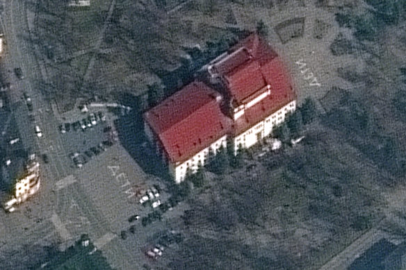 The Mariupol Drama Theatre in Mariupol, Ukraine, on Monday, with the word “children” painted on the ground at the front and back of the building.