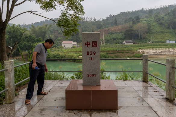 A man checks if a China-Vietnam boundary marker is damaged in Detian Village in September. 