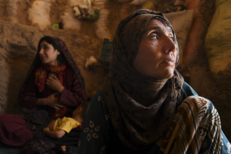 "Whatever we have [is] left in ruins": Del Jan, blind from cataracts, in her temporary shelter in the camp.