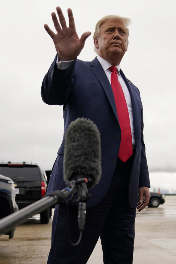 US President Donald Trump walks away from the media to board Air Force One for a trip to a campaign rally in Michigan.