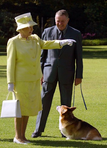 The late Queen Elizabeth II meets a corgi owner from the Adelaide Hills Kennel Club at Government House in Adelaide on February  28, 2002.