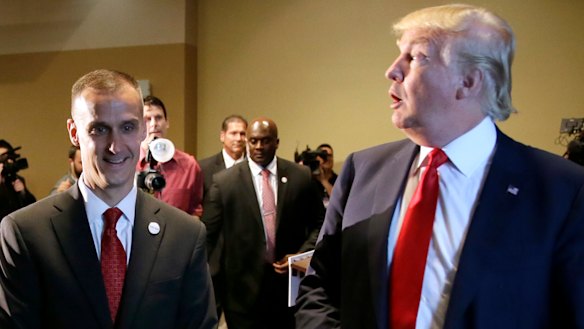 In this 2015 photo, Donald Trump walks with his then-campaign manager Corey Lewandowski after speaking at a news conference in Iowa.