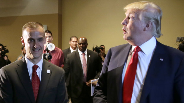 In this 2015 photo, Donald Trump walks with his then-campaign manager Corey Lewandowski after speaking at a news conference in Iowa.