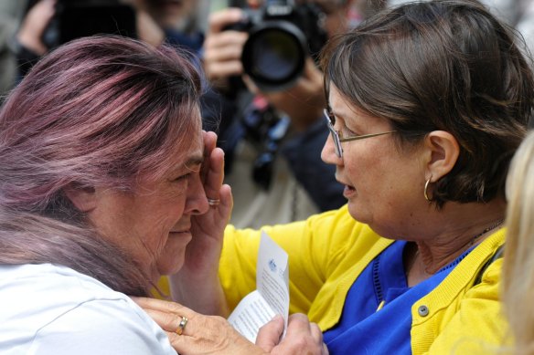An emotional Tina Gasmi is comforted by Leonie Sheedy outside the royal commission into child sexual abuse in 2013.