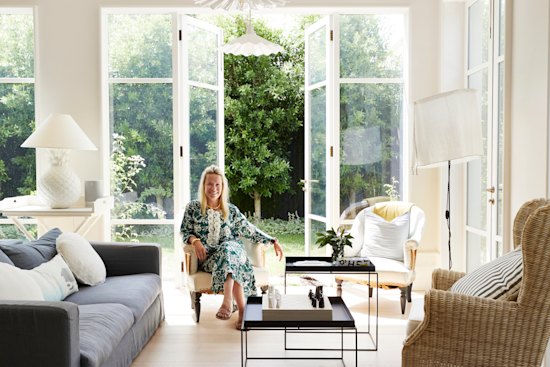 “I grew up in the country and my husband in the city; our home reflects both,” says Carrie Gourlay, seated in the open-plan space that opens out to a garden designed by Paul Bangay.