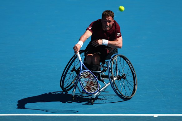 Alfie Hewett serves.