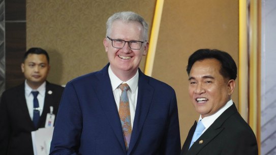 Home Affairs Minister Tony Burke, left, shakes hands with Indonesian Coordinating Minister for Legal, Human Rights, Immigration and Correctional Affairs, Yusril Ihza Mahendra.