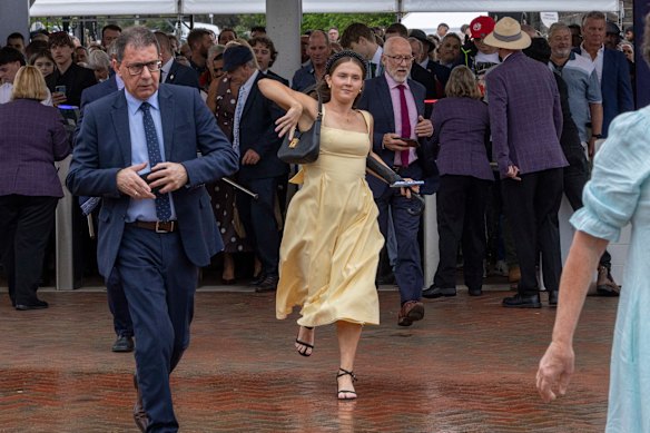 Punters scramble through the entry gates at Flemington.