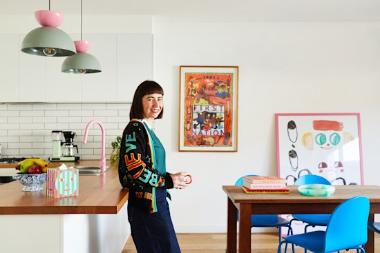 “The kitchen bench faces the backyard, a design feature we mimicked from the original house,” says Sarah Auld. “My uncle, Martin, made the dining table from spotted gum.” The “Arcade” pendant lights and “Fun” chairs are by Dowel Jones and the pink tapware is from Par Taps in Preston.