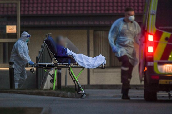 A resident is evacuated from St Basil’s nursing home in July 2020.