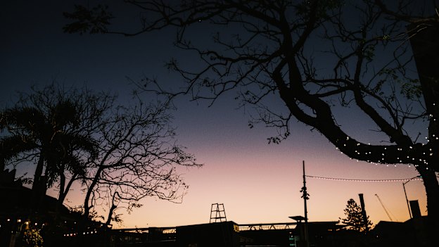 Sunset peeks over Suncorp Stadium, which looms over the tiny suburb of Petrie Terrace.