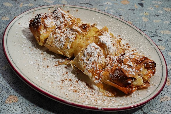 Custard-filled bougatsa dusted with icing sugar.