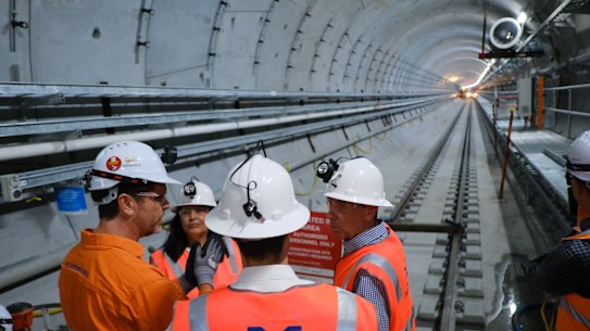 Deputy Premier Cameron Dick, State Development Minister Grace Grace and Transport Minister Bart Mellish view the entrance to one of the train tunnels exiting the now-constructed platform and mezzanine levels of the Albert Street Station being built for Cross River Rail in the Brisbane CBD. 