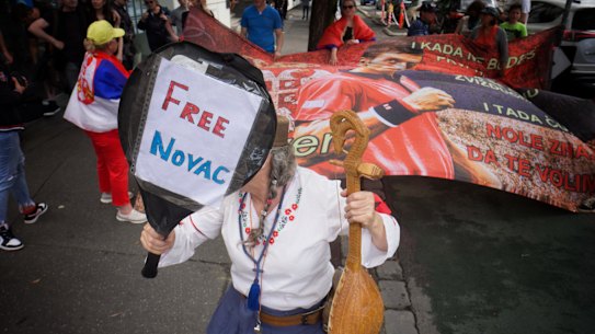 Supporters of Novak Djokovic gather outside the Melbourne hotel where he is being detained.