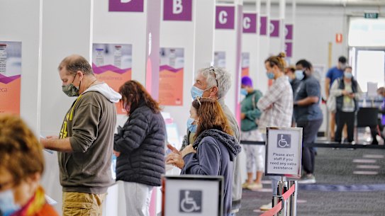 People attend the Barwon Health COVID-19 Vaccination Hub at the old Ford Factory in Geelong.