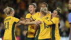 Australian players celebrate scoring against France in their friendly in Melbourne on Friday.