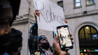 Protesters gather in front of  the New York Stock Exchange after Robinhood curbed trading in GameStop.