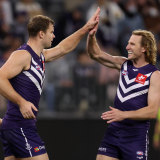 David Mundy, right, celebrates a goal with Sean Darcy.