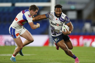 Melbourneâ€™s Justin Olam attempts to fend off Kurt Mann of the Knights.