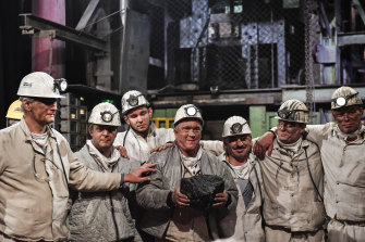 Miners hold the last lump of coal during a closing ceremony of the last German coal mine Prosper-Haniel in Bottrop on December 21, 2018. 
