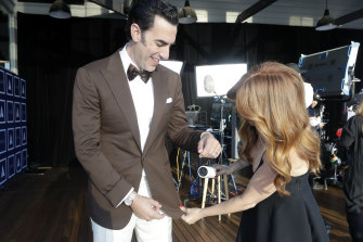 Isla Fisher puts the final touches on Sacha Baron Cohen in Sydney before the Oscars.