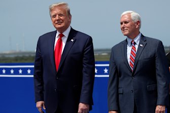 President Donald Trump stands with Vice-President Mike Pence as they wait to view the SpaceX flight to the International Space Station.