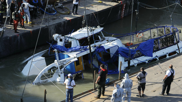 The bridge of the sunk shipwreck surfaces during the recovery operation on Tuesday at Margaret Bridge, the scene of the fatal boat accident in Budapest, Hungary.