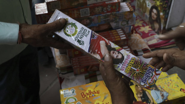 Indians shop for green firecrackers ahead of Diwali festival in Delhi. 