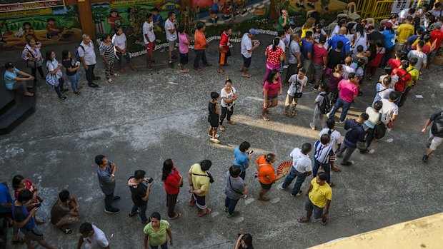 Voters wait in line to cast their ballots at a polling station during the mid-term election.