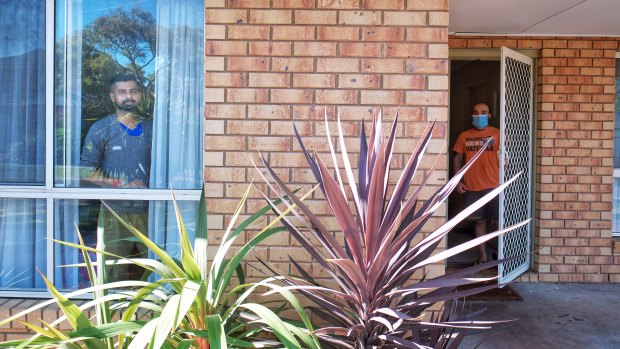 Student Dipjyoti Goswami (left) and COVID-positive housemate Rushi Jaiswal keep their distance at home in Kingsbury.