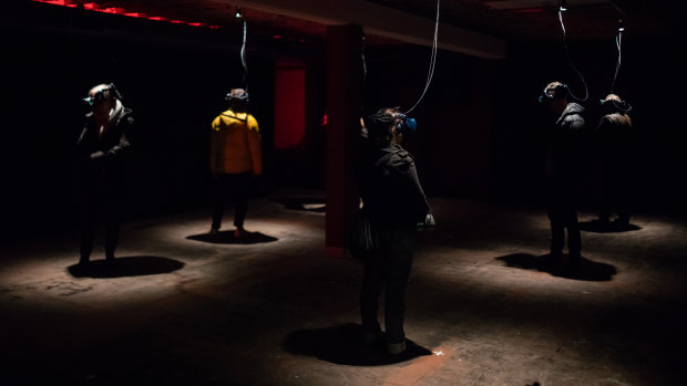 People viewing Paul McCarthy's VR work at Dark Mofo 2019.